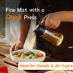 Person seasoning a salad with a bottle labeled 'Quick Press' on a wooden table.